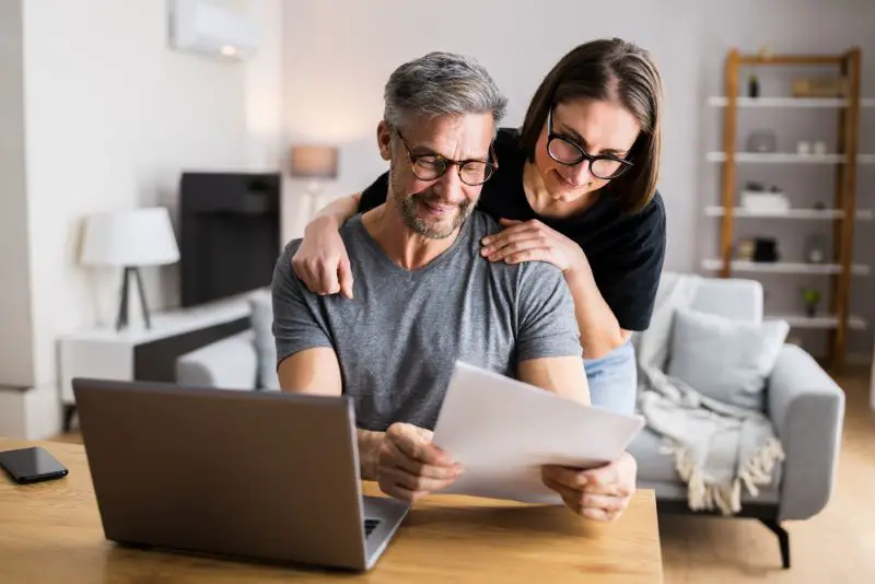 Couple Doing Taxes And Family Budget On Computer