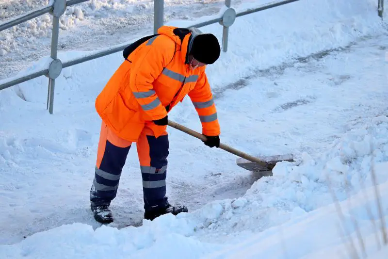 Snow removal in winter city, street cleaning.