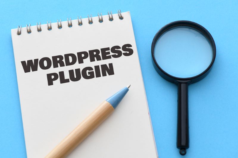 Business concept.Text Wordpress Plugin writing on note