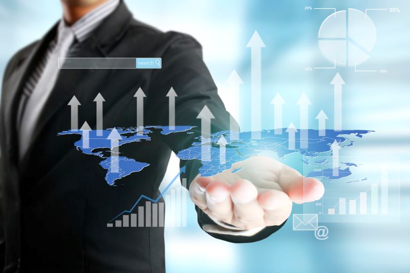 Businessman with financial symbols coming
