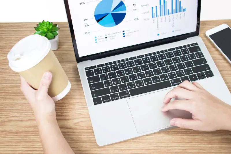 Side view picture of businessman analyzing financial graphs