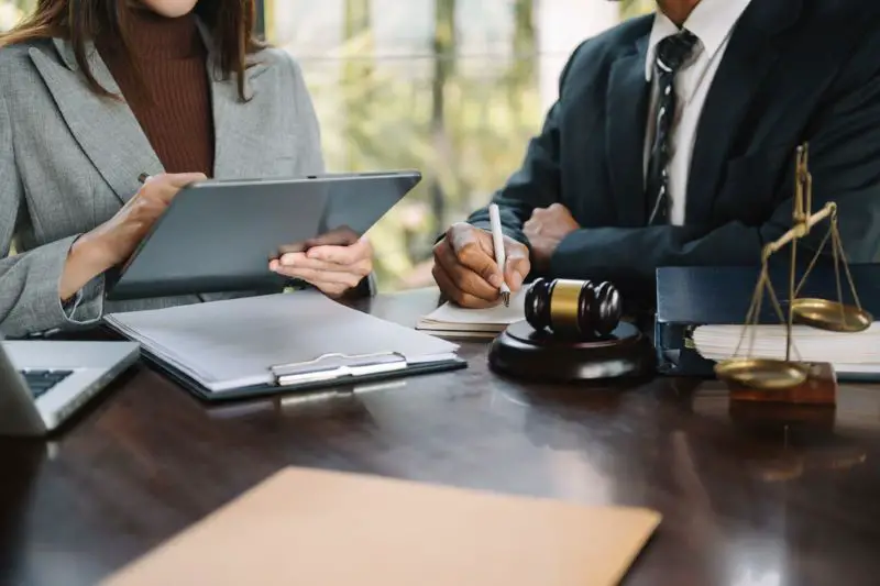Lawyers discussing contract papers sitting at the table