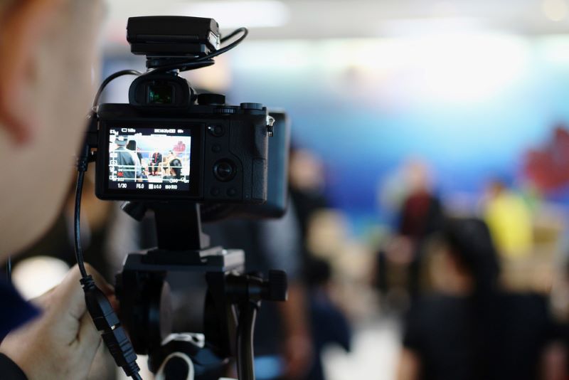 The media is recording video during the press conference