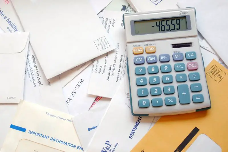 Calculator on top of past due overdue bills and letters