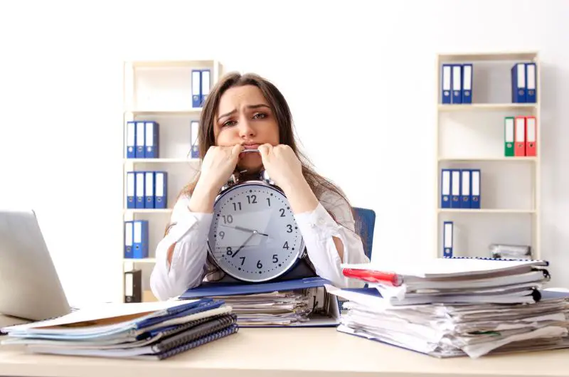 Young female employee unhappy with excessive work