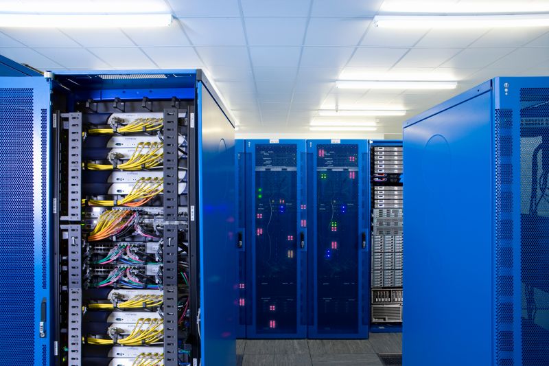 Rows of Blue Server Racks with Cables