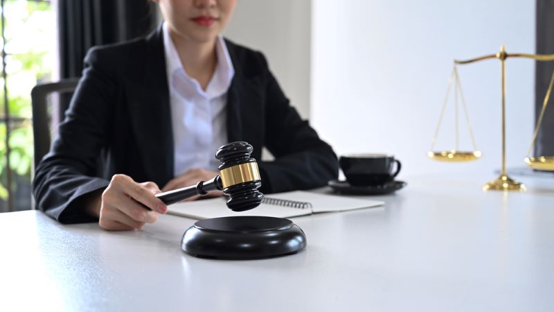 Close up view female judge or lawyer holding a gavel in hand