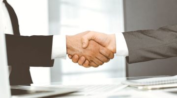 Unknown diverse business people are shaking hands