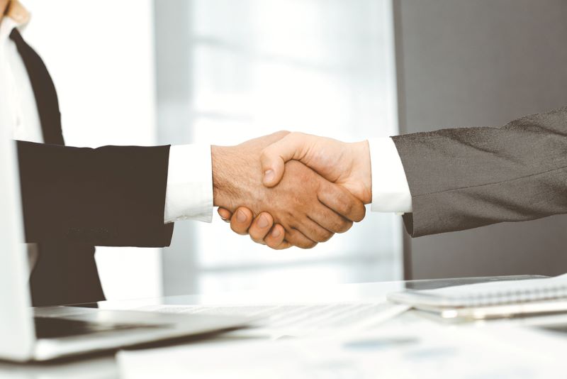 Unknown diverse business people are shaking hands