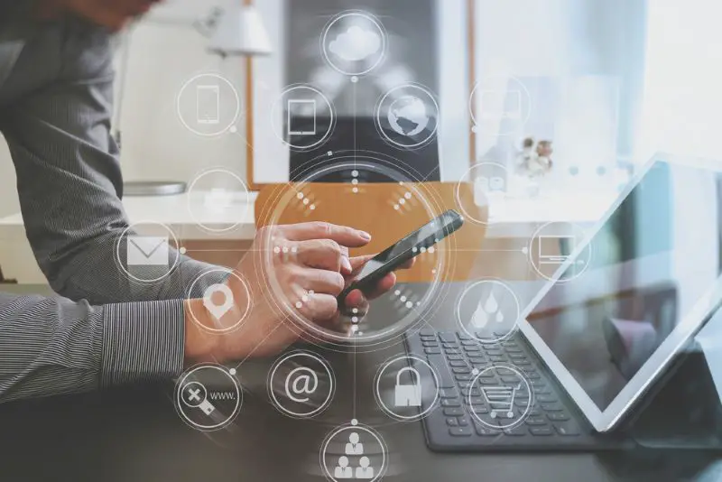 Hand using smart phone and digital tablet computer for online banking