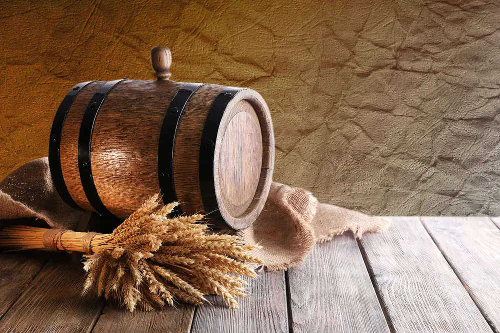 Old barrel with wheat on table