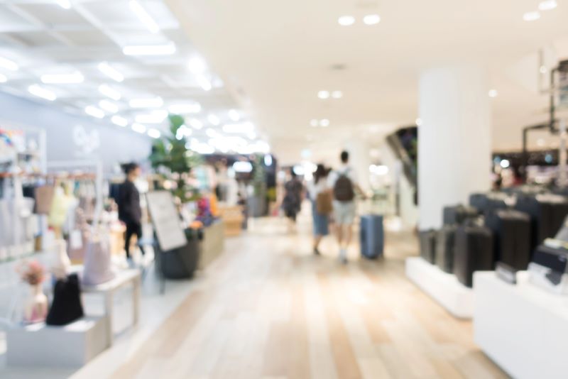 Abstract blur defocused shopping mall with retail shoppers.