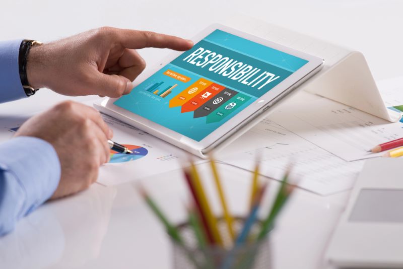Businessman working on tablet - reponsibility on screen