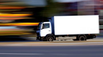 White delivery truck on the road - blurred background