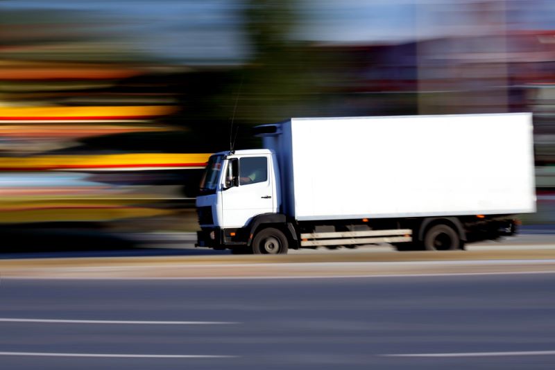 White delivery truck on the road - blurred background