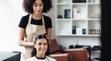 Beauty master making new hairstyle for young woman