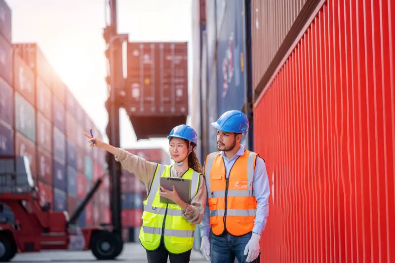 Foreman man and worker working checking at Container cargo,Logistics import export shipping concept.