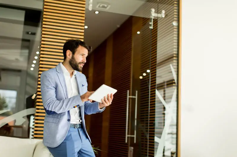 Property manager with tablet standing in the office