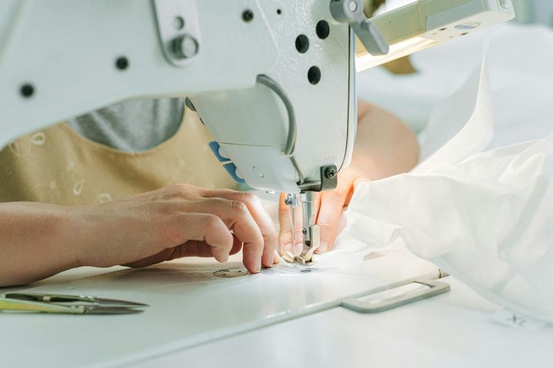 Hands of a machinist using an industrial sewing machine