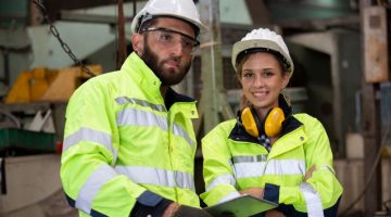 Male and female engineers conduct inspections and check the production process in the factory.