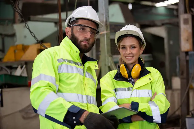 Male and female engineers conduct inspections and check the production process in the factory.