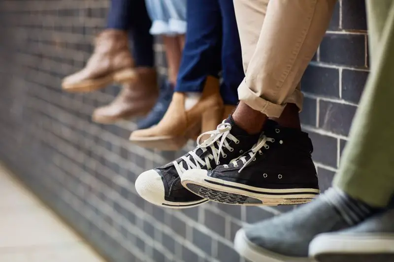 Just chilling – feet of people chilling on a wall