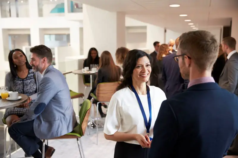 Group of people networking during a coffee break at a conference