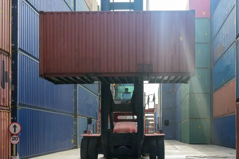 Worker moving a container at a container yard