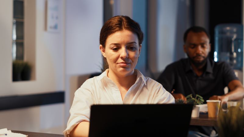 Startup employee working on a laptop on corporate project