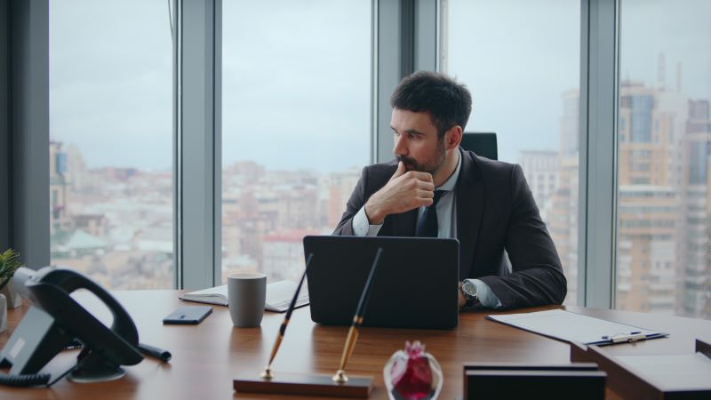 Office worker in luxury office deep in thought