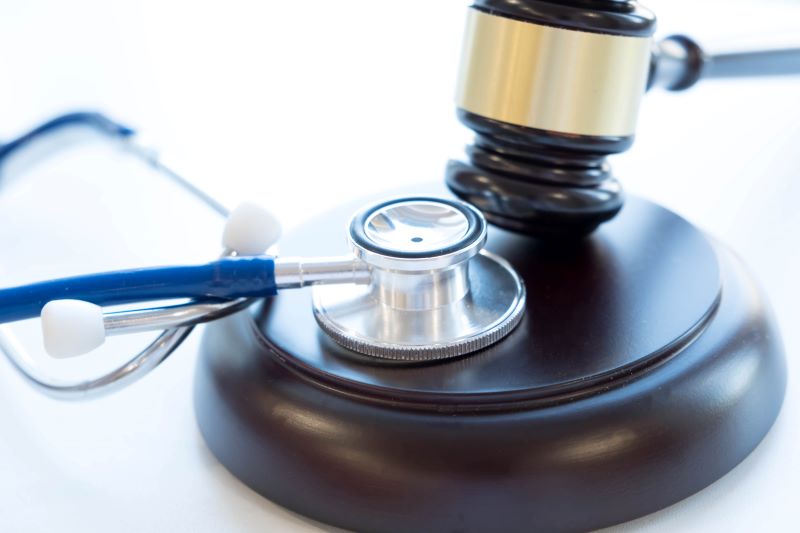 Gavel and stethoscope. Medical jurisprudence. Legal definition of medical malpractice.