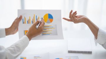 Statisticians analysing data and charts