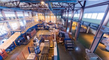 Fiberglass production industry equipment at manufacture background