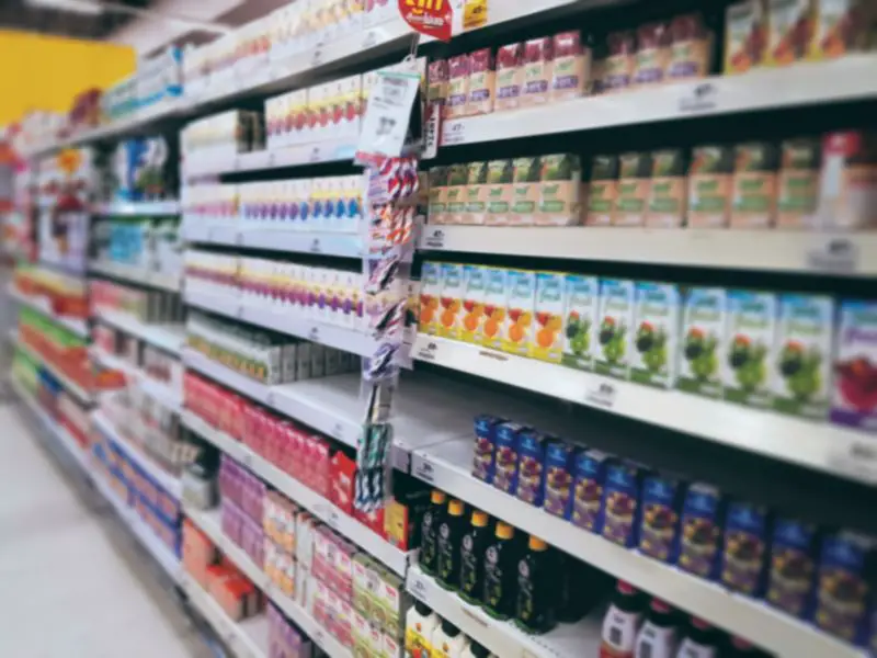 Blurred Background of Juice Boxes on Shelves at Grocery Store
