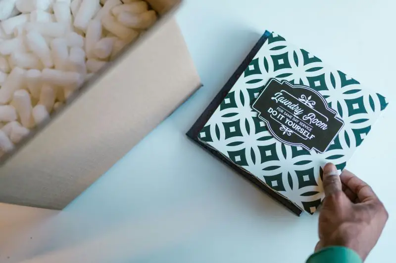 Packing Peanuts in Cardboard Box next to a product to go into the box