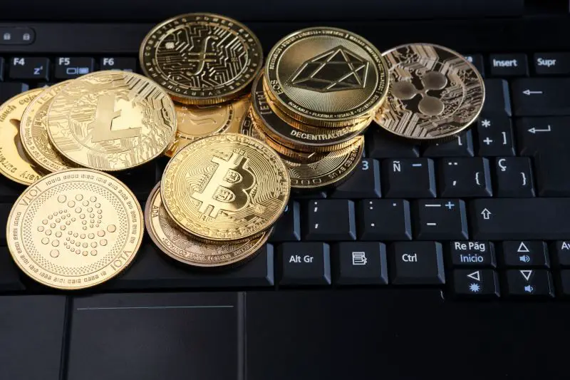 Various cryptocurrency coins on a laptop computer keyboard