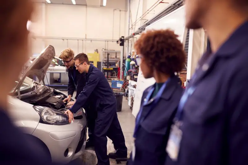 Auto Mechanic Apprenticeship At College Working On Car Engine