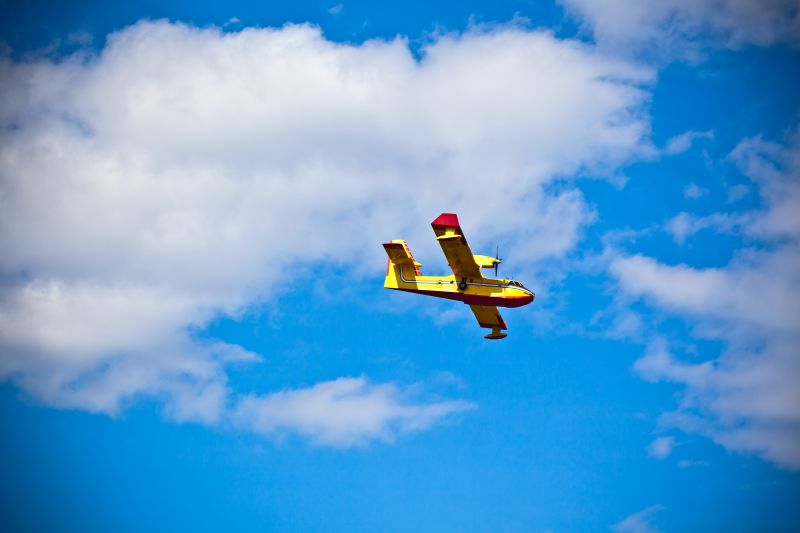 Bright Yellow Firefighter remote airplane in a Blue Sky