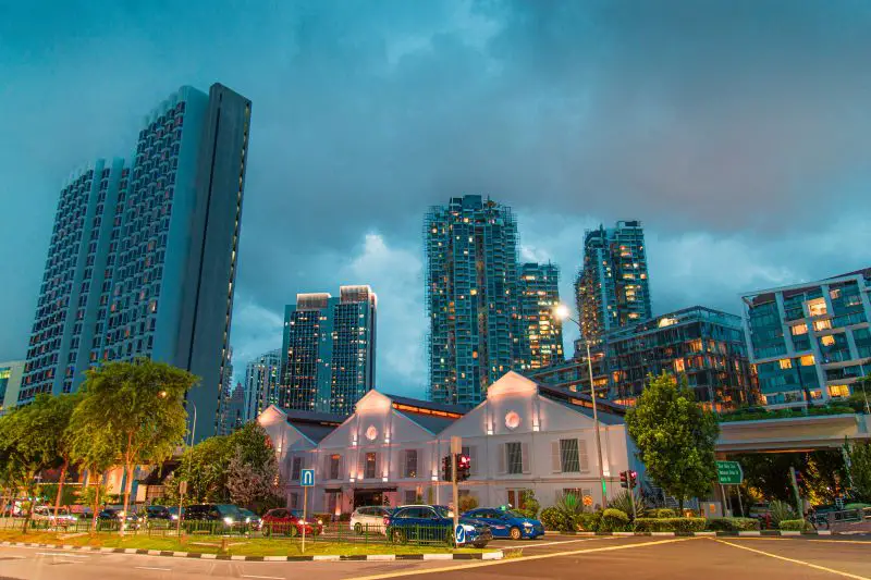 General view from Singapore skyscrapers and flats among green streets during twilight