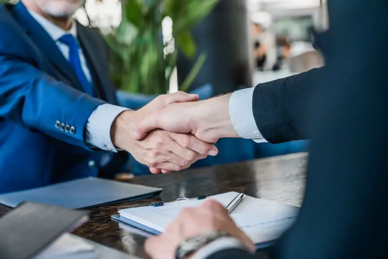 Hands of businessmen shaking after agreement on meeting
