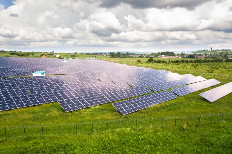 Aerial view of solar power plant on green field.