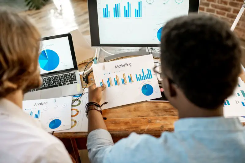 Coworkers working together with marketing analytics