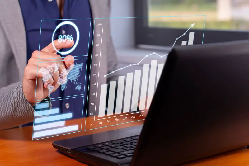 Businessman Analyzing Rising Graphs in Modern Office