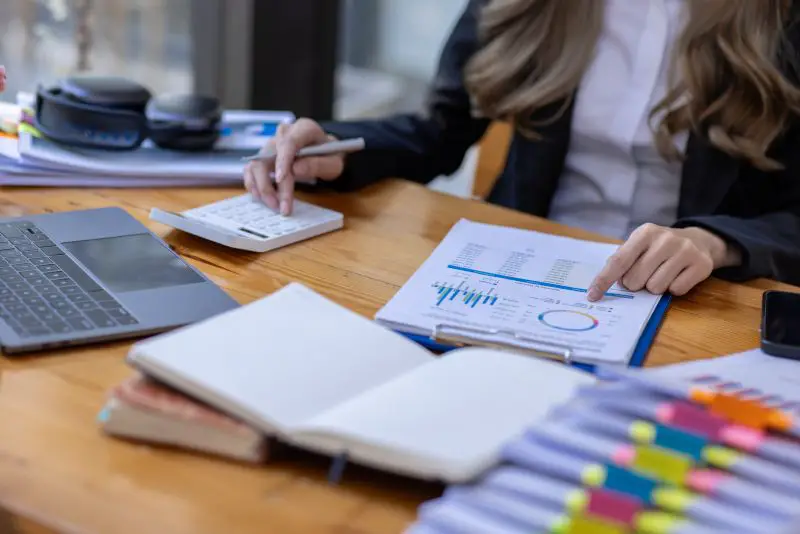 woman accountant Bookkeeper working on calculator to calculate business data