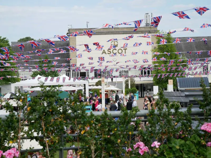 People standing outside a building at Ascot racecourse