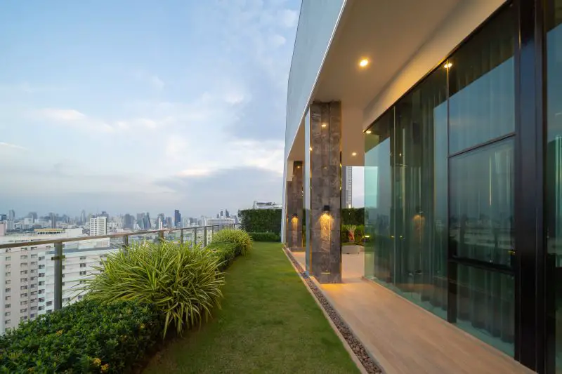 Sky garden on private rooftop of condominium or hotel, high rise architecture building, grass field