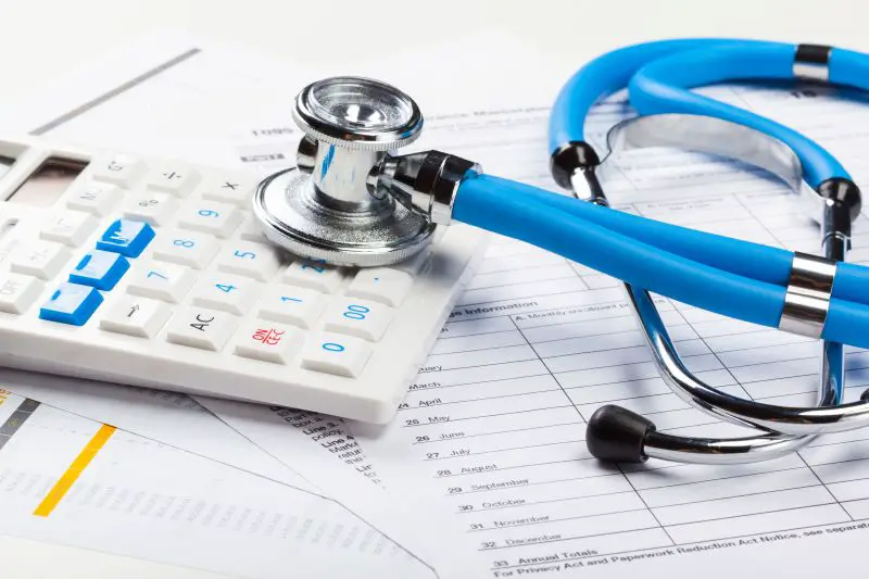 Health care costs. Stethoscope and calculator