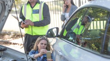 Woman and policeman at car accident scene