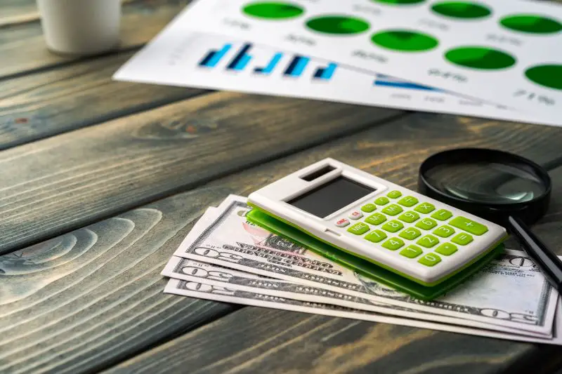 Business graphs paper and calculator on table