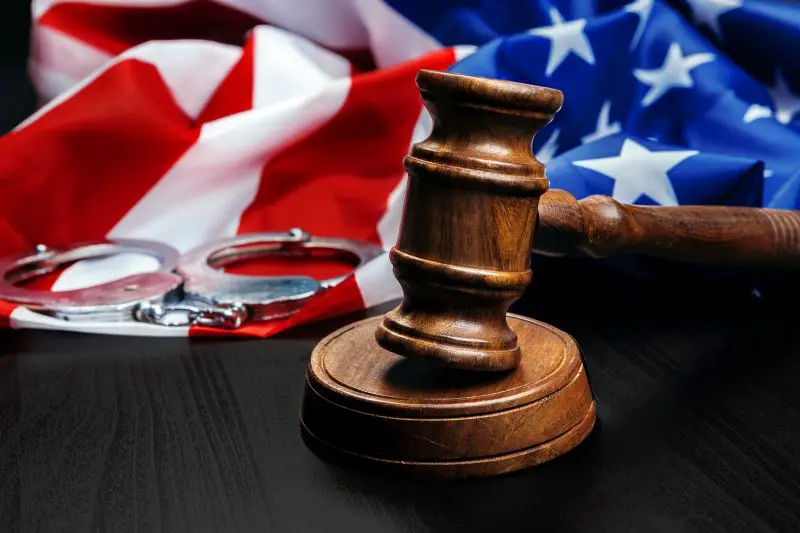 Gavel on wooden table with USA flag